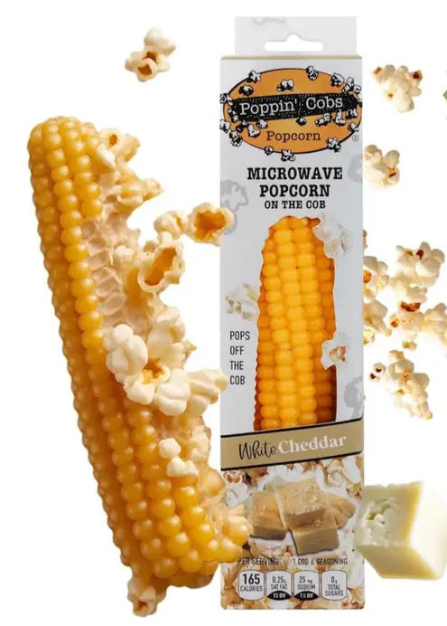 Poppin' Corn microwave popcorn on the cob with packaging and scattered popcorn pieces.
