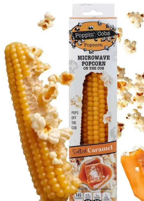 Poppin' Cobs Popcorn on a cob with packaging and caramel pieces on a white background